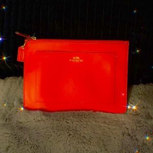 Coach  orange leather clutch doesn’t have tag but brand new never been used